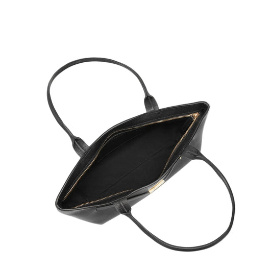 Black handbag with gold zipper on a light gray background